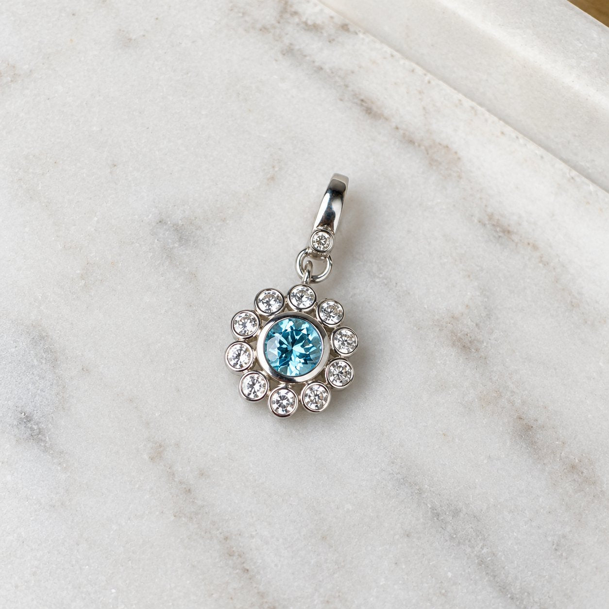 Sterling Silver Flower Charm with Blue + White Topaz